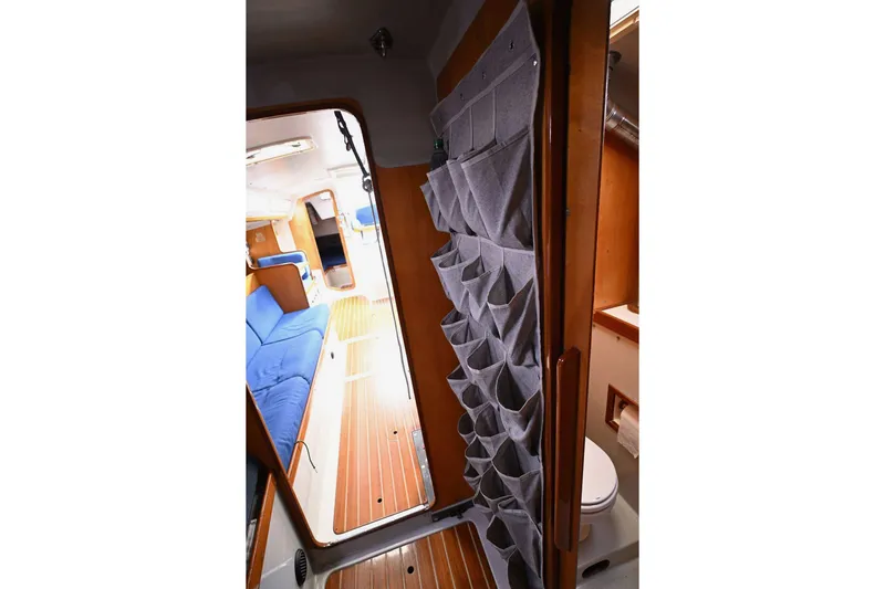 Slide: The Image of Interior of 1992 Santa Cruz 52 yacht with blue seating and wooden flooring. - 26