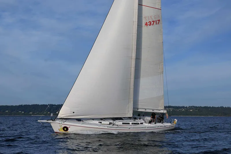 Slide: The Image of Sailing yacht Santa Cruz 52 from 1992 on open water under clear skies. - 11