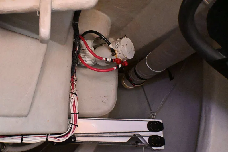 Slide: The Image of Interior view of a 1992 Santa Cruz 52 sailboat, showcasing wiring and mechanical components. - 56