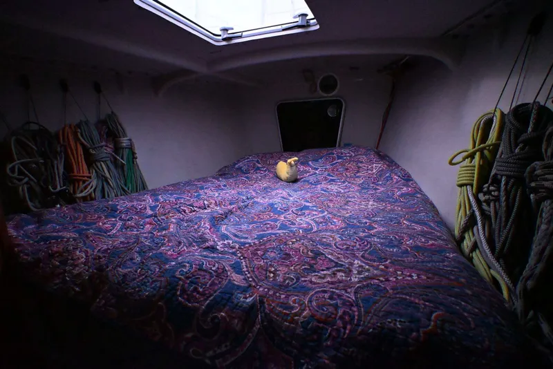 Slide: The Image of Cozy cabin interior of 1992 Santa Cruz 52 sailboat with colorful ropes and patterned bedding. - 25