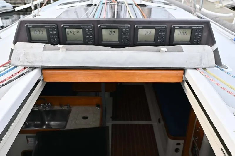 Slide: The Image of Cockpit of 1992 Santa Cruz 52 sailboat with navigation instruments and cabin entrance. - 32