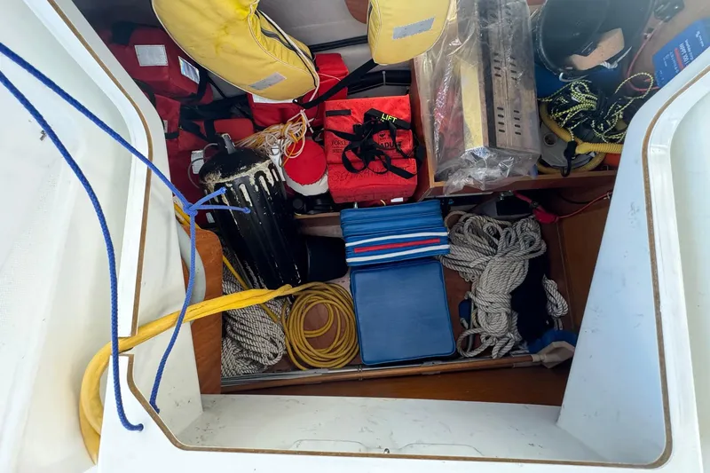 Slide: The Image of Storage compartment of 2018 Jeanneau Sun Odyssey 389 with ropes, life jackets, and equipment. - 60