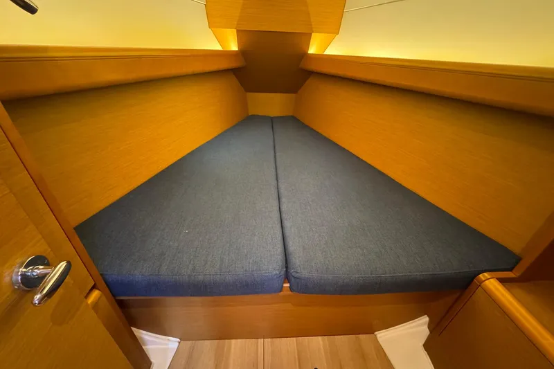 Slide: The Image of Interior cabin of 2018 Jeanneau Sun Odyssey 389 sailboat with blue cushions. - 48