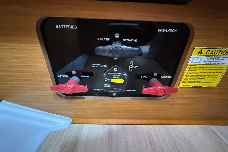 Slide: The Image of Electrical panel of 2018 Jeanneau Sun Odyssey 389 sailboat with battery and breaker controls. - 55