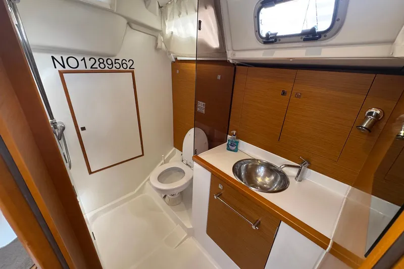 Slide: The Image of Bathroom interior of 2018 Jeanneau Sun Odyssey 389 yacht, featuring sink and toilet. - 51