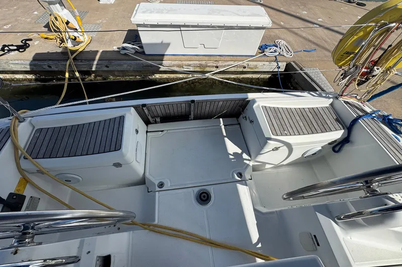 Slide: The Image of 2018 Jeanneau Sun Odyssey 389 cockpit with seating and dock view. - 25