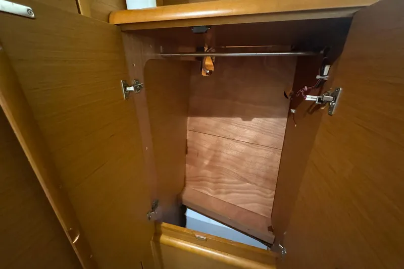 Slide: The Image of Open wooden cabinet inside 2018 Jeanneau Sun Odyssey 389 sailboat. - 50