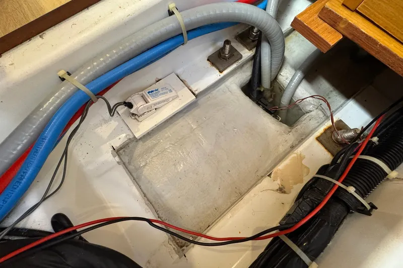 Slide: The Image of Bilge area of 2018 Jeanneau Sun Odyssey 389 sailboat with wiring and hoses. - 62