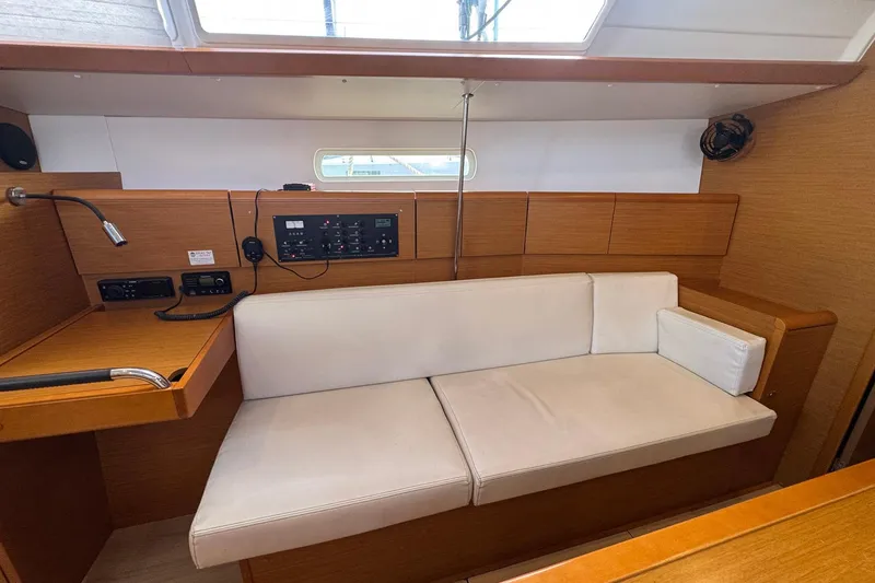 Slide: The Image of Interior of 2018 Jeanneau Sun Odyssey 389 yacht with white seating and control panel. - 38