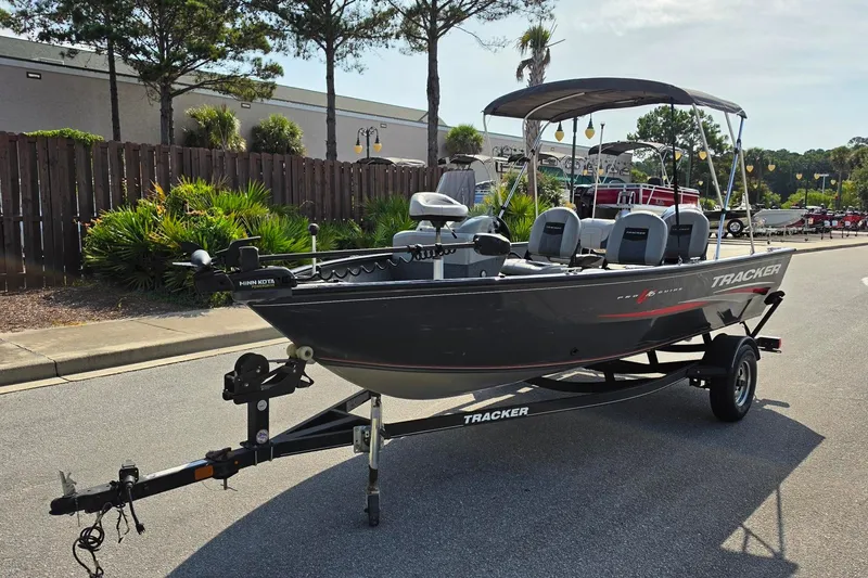 Slide: The Image of 2019 Tracker Pro Guide V-16 SC boat on trailer, parked outdoors. - 16
