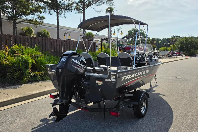 Slide: The Image of 2019 Tracker Pro Guide V-16 SC boat with Mercury 50 engine on trailer. - 18