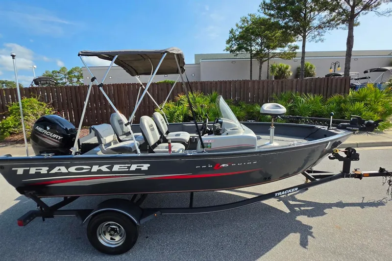 Slide: The Image of 2019 Tracker Pro Guide V-16 SC boat with Mercury engine on trailer, parked outdoors. - 13
