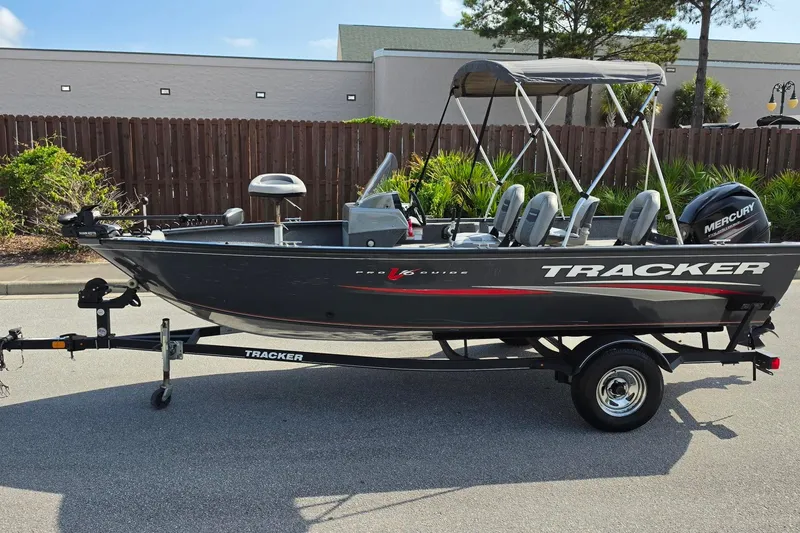 The Image of 2019 Tracker Pro Guide V-16 SC fishing boat with Mercury outboard motor on trailer. - 0