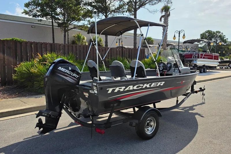 Slide: The Image of 2019 Tracker Pro Guide V-16 SC boat with Mercury outboard motor on trailer. - 14