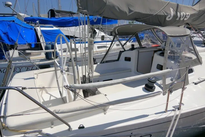 Slide: The Image of 2004 J Boats J/109 sailboat with covered cockpit, docked in marina. - 34