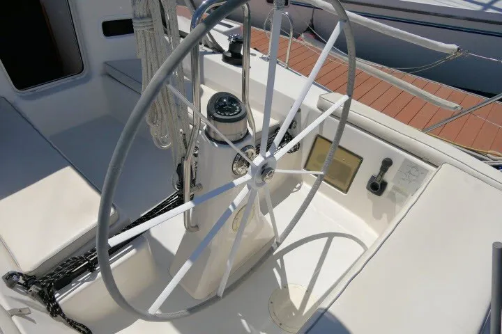 Slide: The Image of Steering wheel of a 2004 J Boats J/109 sailboat, featuring navigation instruments. - 49