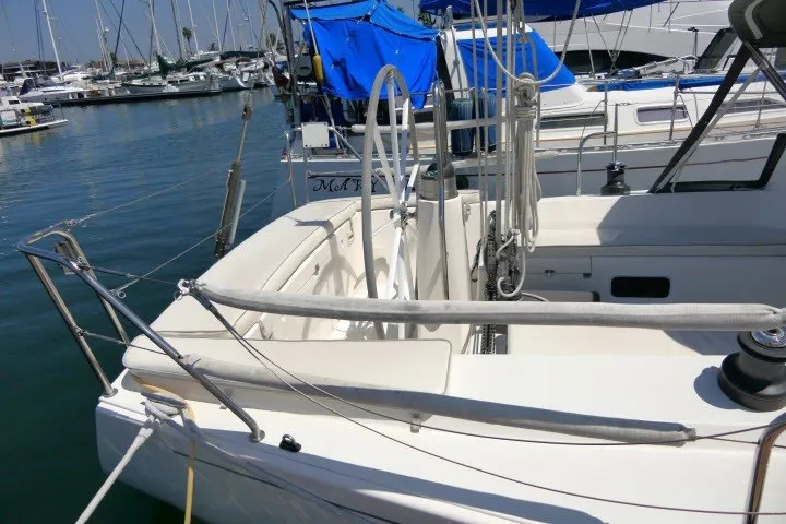 Slide: The Image of 2004 J Boats J/109 sailboat docked in marina, featuring spacious cockpit and sleek design. - 45