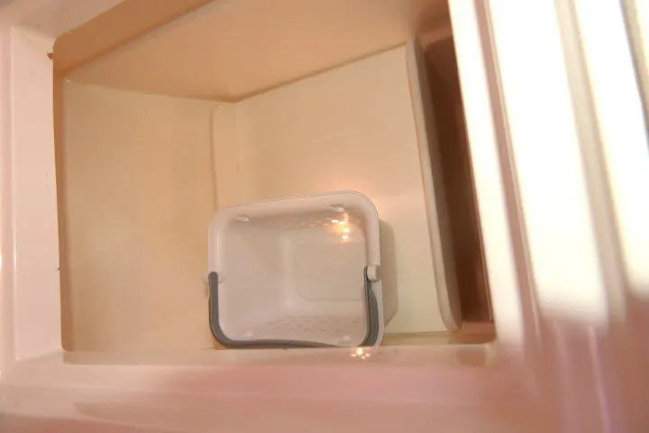 Slide: The Image of Storage compartment with a small white basket inside a 2004 J Boats J/109. - 21