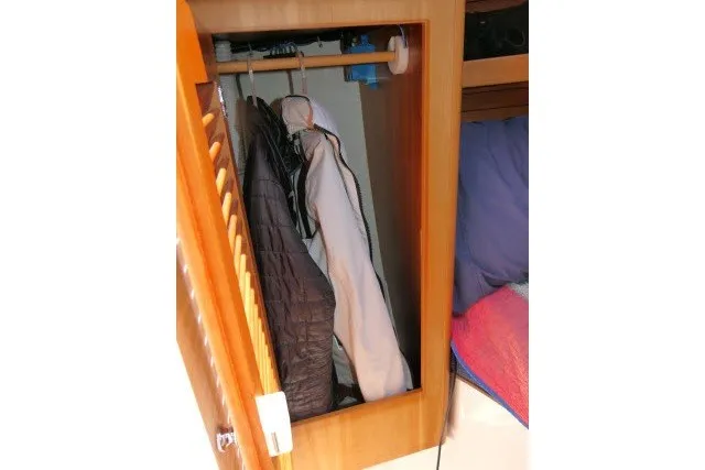 Slide: The Image of Small wooden closet with hanging jackets inside a 2004 J Boats J/109 sailboat. - 26