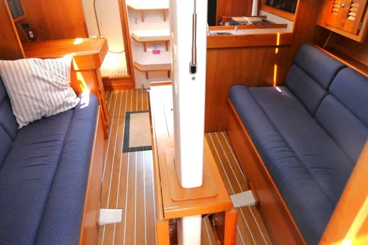 Slide: The Image of Interior of 2004 J Boats J/109 sailboat with blue seating and wooden finishes. - 15