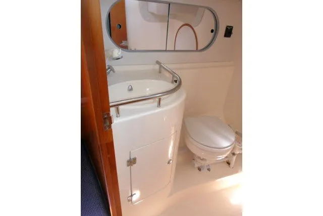 Slide: The Image of 2004 J Boats J/109 yacht bathroom with sink, mirror, and toilet. - 31
