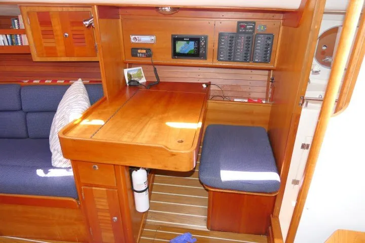 Slide: The Image of 2004 J Boats J/109 interior with navigation station and seating area. - 12