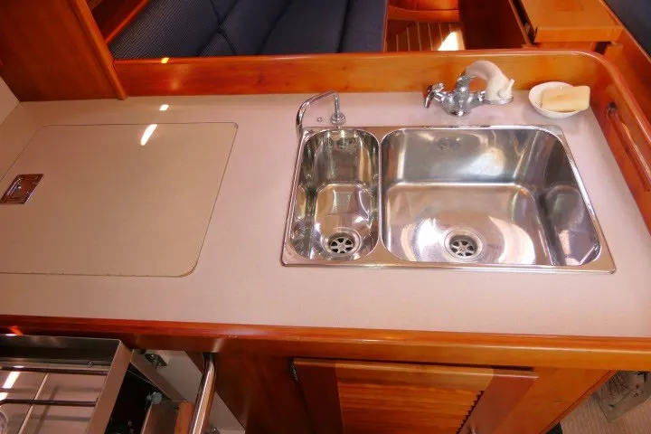 Slide: The Image of 2004 J Boats J/109 yacht interior with dual stainless steel sink in wooden galley. - 23