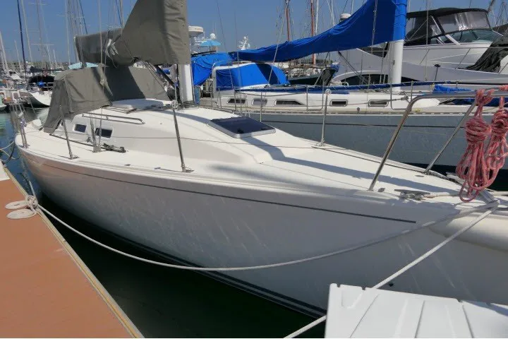 Slide: The Image of 2004 J Boats J/109 sailboat docked in marina, covered sails, clear sky. - 69