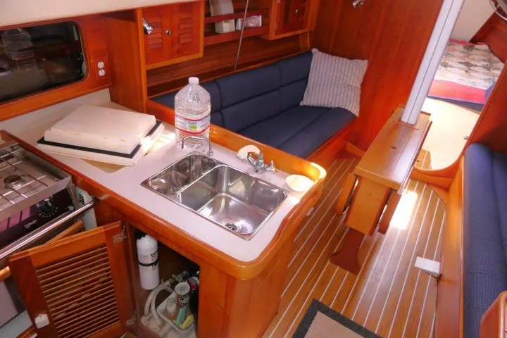 Slide: The Image of Interior of a 2004 J Boats J/109 sailboat with kitchen and seating area. - 3