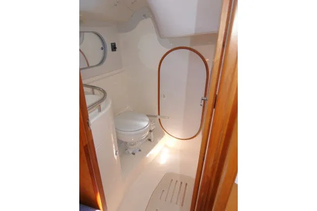 Slide: The Image of 2004 J Boats J/109 yacht bathroom with toilet and wooden accents. - 29