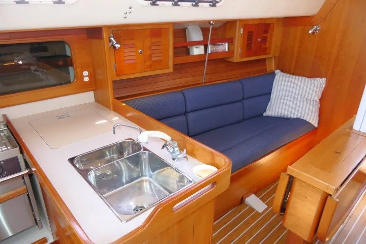 Slide: The Image of Interior of 2004 J Boats J/109 sailboat with kitchen and seating area. - 4