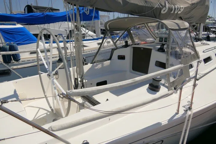 Slide: The Image of 2004 J Boats J/109 sailboat cockpit with dual steering wheels and protective canopy. - 35
