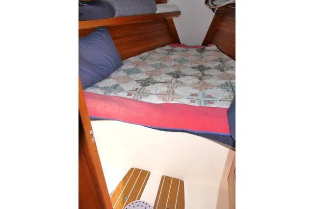 Slide: The Image of Cozy cabin interior of 2004 J Boats J/109 with quilted bedding and wooden accents. - 24