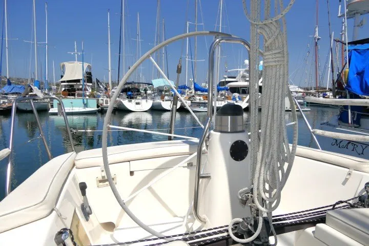 Slide: The Image of 2004 J Boats J/109 sailboat cockpit with wheel, docked in a marina. - 47