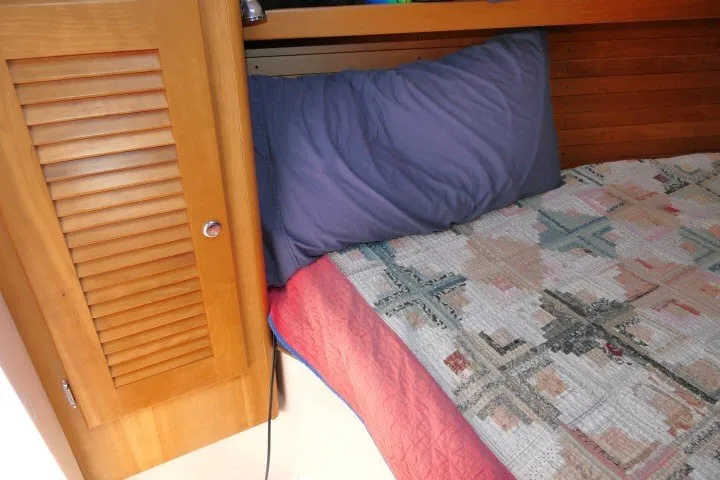 Slide: The Image of Cozy cabin interior of 2004 J Boats J/109 with quilted bedding and wooden paneling. - 25