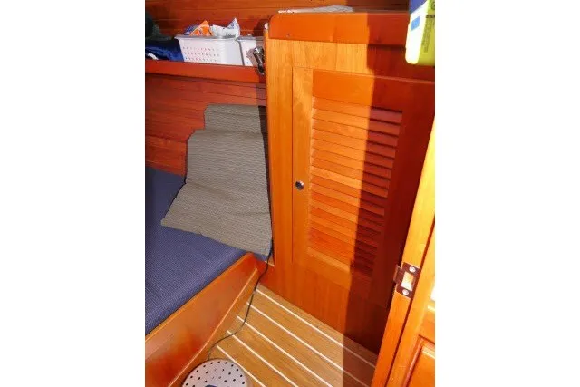 Slide: The Image of Interior cabin of 2004 J Boats J/109 with wooden paneling and striped flooring. - 33