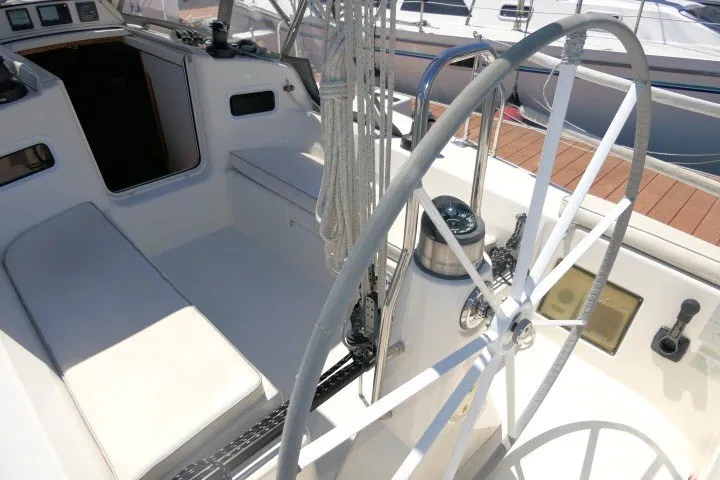 Slide: The Image of Cockpit of 2004 J Boats J/109 sailboat with steering wheel and seating area. - 43