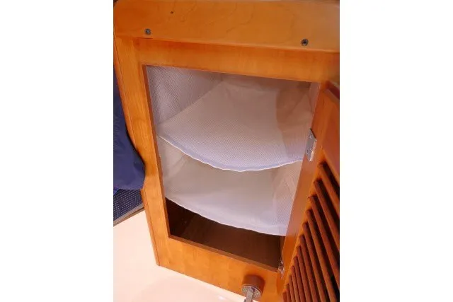 Slide: The Image of Wooden cabinet with mesh storage inside, from a 2004 J Boats J/109 sailboat. - 28