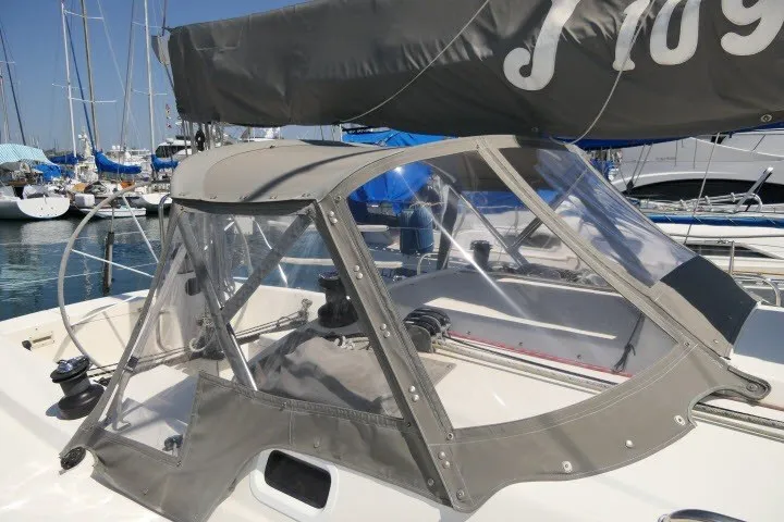 Slide: The Image of 2004 J Boats J/109 sailboat with cockpit cover in marina setting. - 52