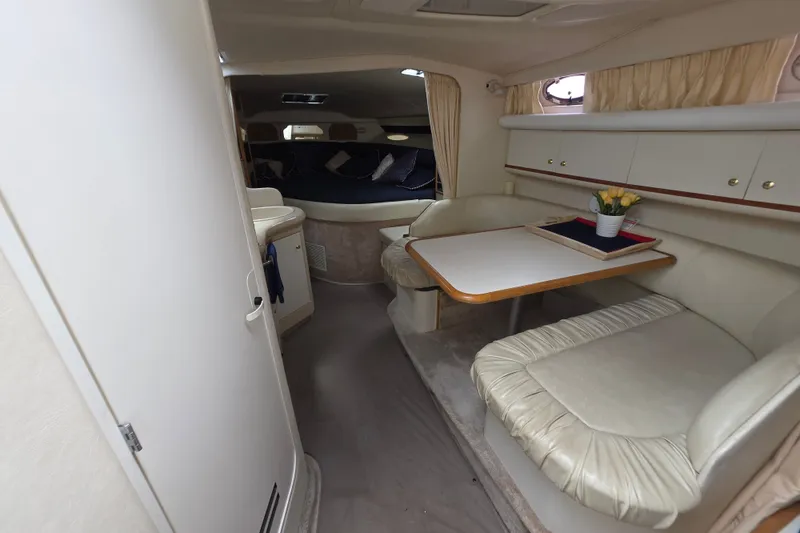 Slide: The Image of Interior of 1999 Sea Ray Sundancer 330, featuring cozy seating and dining area. - 3