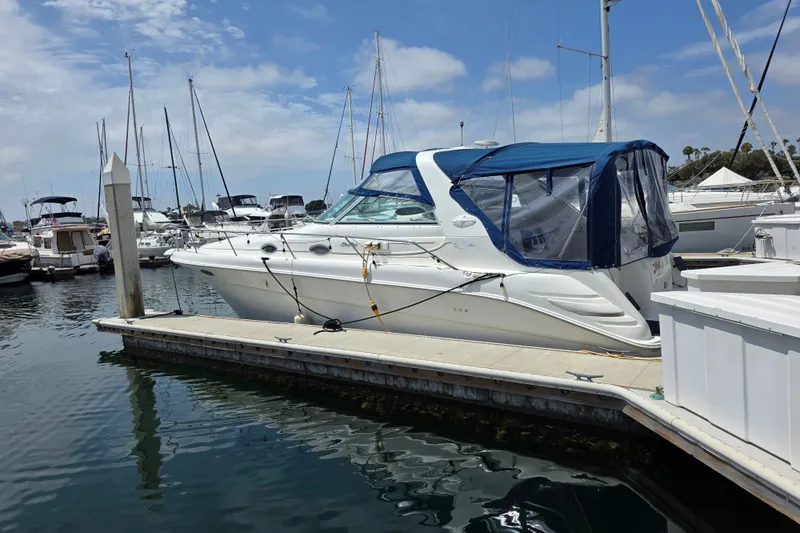 Slide: The Image of 1999 Sea Ray Sundancer 330 yacht docked at marina with blue canopy. - 8