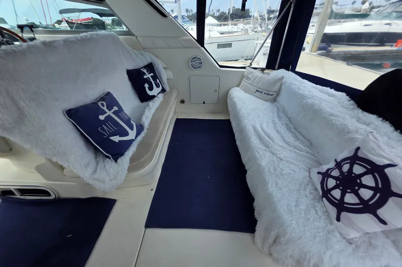 Slide: The Image of Interior of a 1999 Sea Ray Sundancer 330 with nautical-themed cushions and plush seating. - 6