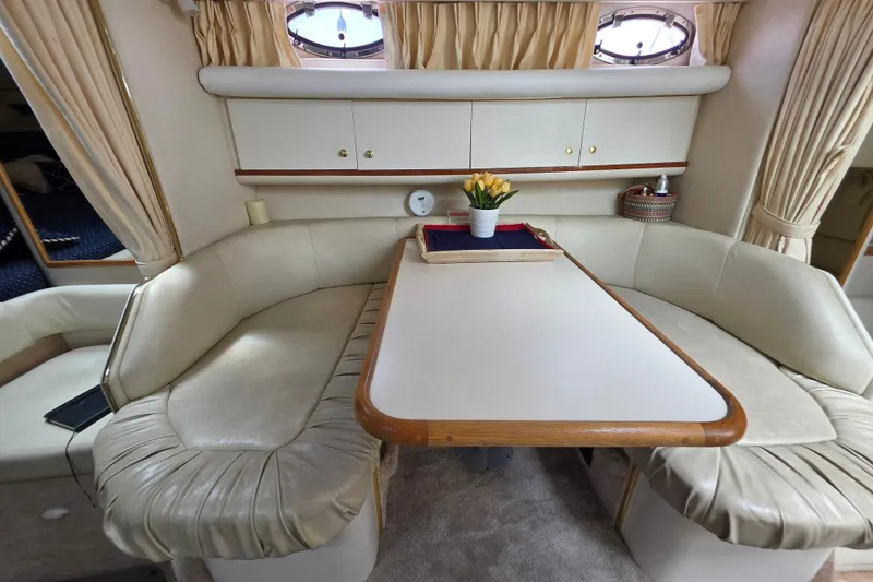 Slide: The Image of Interior of 1999 Sea Ray Sundancer 330 with cozy seating and elegant table setting. - 1