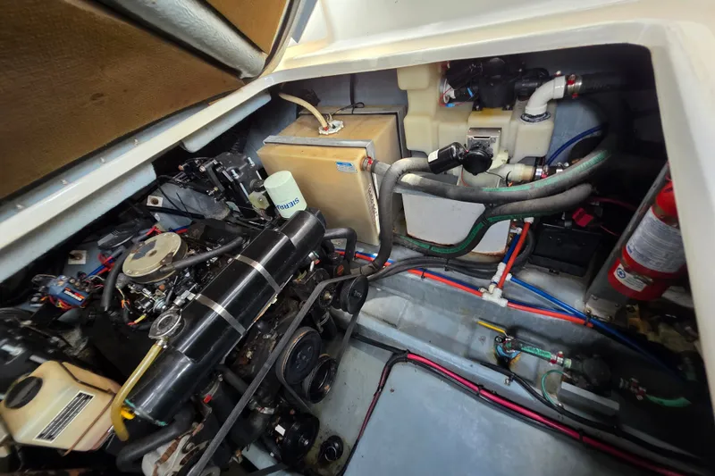 Slide: The Image of Engine compartment of a 1999 Sea Ray Sundancer 330, showcasing mechanical components and wiring. - 11