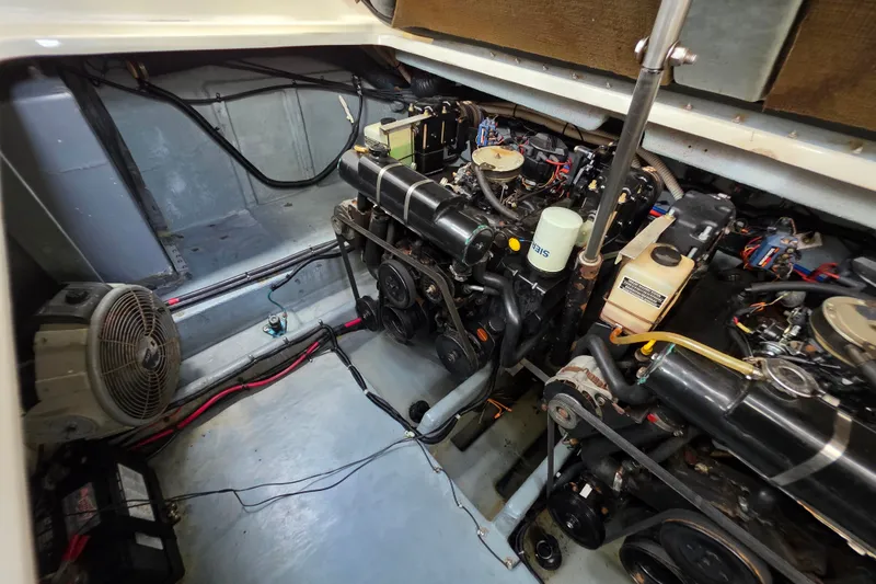 Slide: The Image of Engine room of a 1999 Sea Ray Sundancer 330, showcasing dual engines and mechanical components. - 10