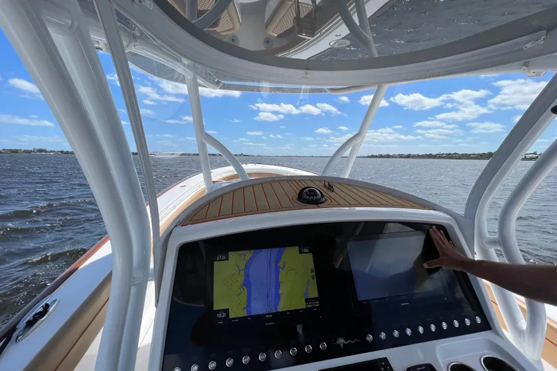 Slide: The Image of Valhalla 33 boat dashboard with navigation screens, cruising on a sunny day, 2020 model. - 4
