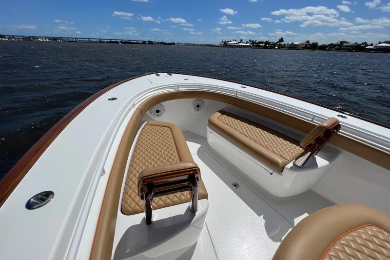 Slide: The Image of Valhalla 33 boat interior with tan quilted seats, 2020 model, on a sunny day. - 10