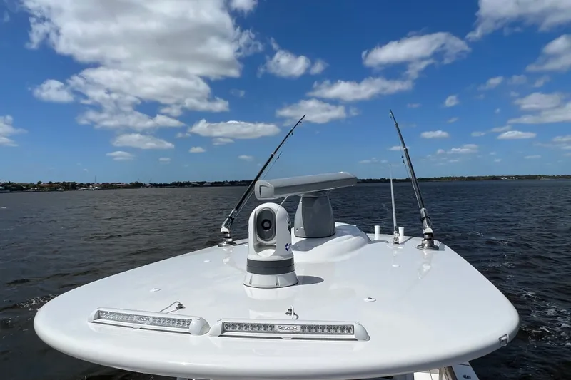 Slide: The Image of Valhalla 33 boat on water, clear sky, fishing rods, 2020 model. - 7
