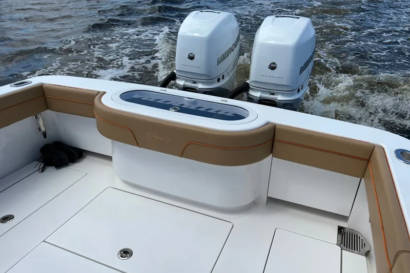 Slide: The Image of 2020 Valhalla 33 boat with twin Mercury outboard engines on water. - 2