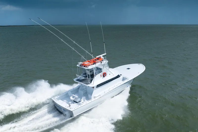 Slide: The Image of Custom Carolina 57 Buddy Cannady 1990 yacht cruising on open water. - 1